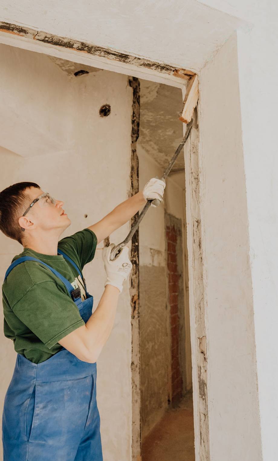 Male worker installing new windows during home renovation process. Copy space.